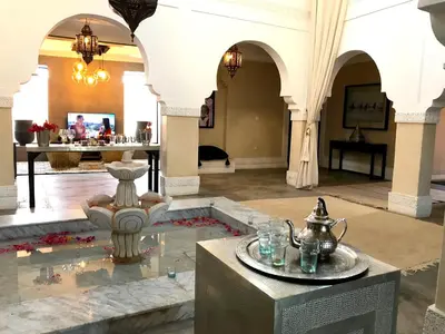 a lobby with a fountain in the middle of a building at Palais Souad in Marrakech