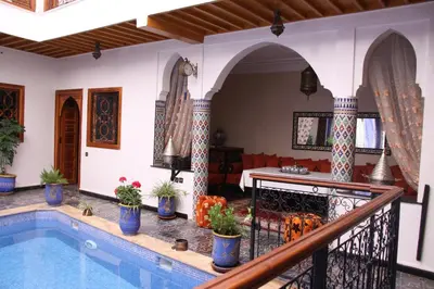 a villa with a swimming pool in a house at Riad La Porte des 5 Jardins in Marrakech