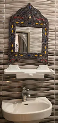 a bathroom with a mirror above a sink at Riad Raffaa in Marrakech