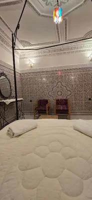 a bedroom with a large bed in a room at Riad Raffaa in Marrakech
