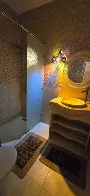 a bathroom with a shower and a sink and a toilet at Riad Raffaa in Marrakech