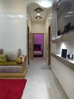 a living room with a couch and a red rug at Theresa apartments in Marrakech
