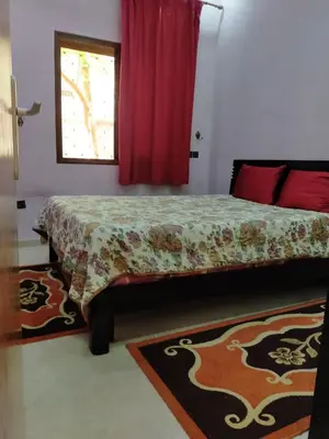 a bedroom with a bed and a window at Theresa apartments in Marrakech
