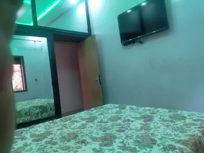 a bedroom with a bed and a flat screen tv at Theresa apartments in Marrakech