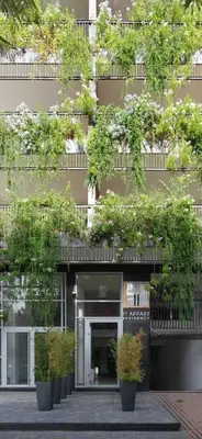 a building with potted plants in front of it at M Appart in Marrakech