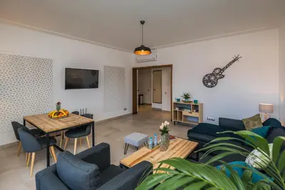 a living room with blue chairs and a table at M Appart in Marrakech