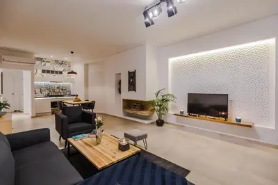 a living room with a couch and a tv at M Appart in Marrakech
