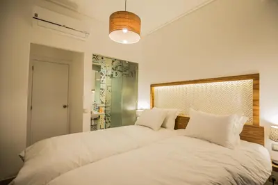 a bedroom with a large white bed with white pillows at M Appart in Marrakech