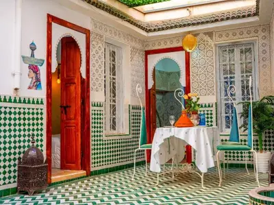 a room with a table and chairs and a door at Dar Sarsar Artistic Music in Marrakech