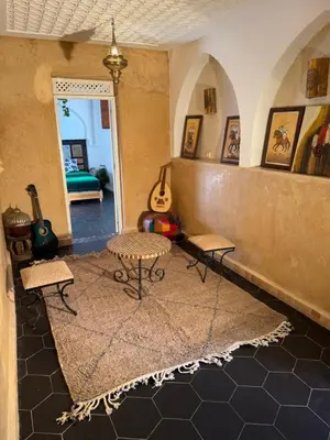 a living room with two chairs and a table at Riad Sarsar Dar dmana in Marrakech