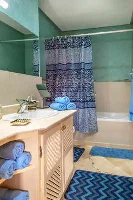 a bathroom with a sink and a bath tub at Majorelle family residence in Marrakech