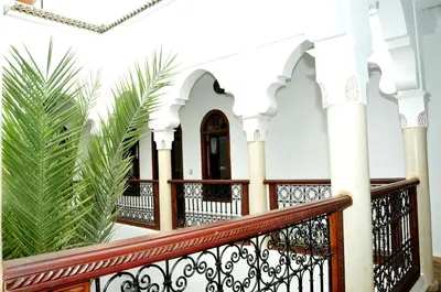 a staircase in a white house with palm trees at Riad Elias & Spa in Marrakech