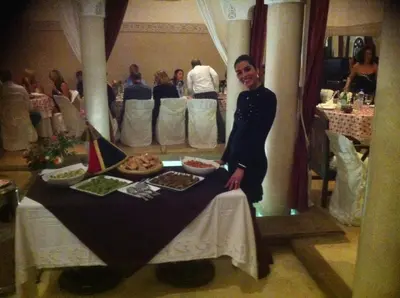a man standing in front of a table with food at Riad Elias & Spa in Marrakech