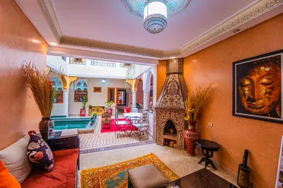 a living room with a couch and a fireplace at Riad Zahri in Marrakech