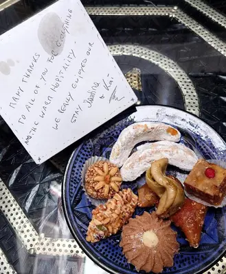 a plate of food on a table with a sign at Riad Zahri in Marrakech