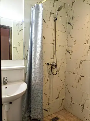 a bathroom with a shower and a sink at Riad familiale à Marrakech in Marrakech