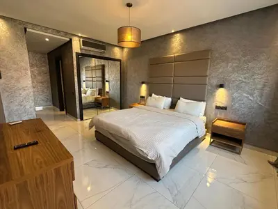 a bedroom with a large bed and a large mirror at Sweet Jacob's Appartment Gueliz City Center in Marrakech