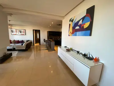 a living room with a couch and a painting on the wall at Sweet Jacob's Appartment Gueliz City Center in Marrakech