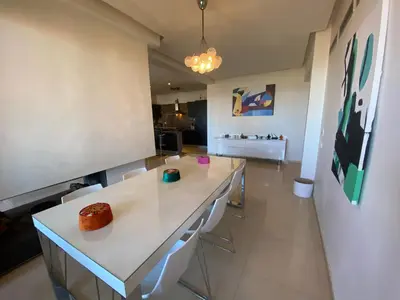a living room with a white counter and chairs at Sweet Jacob's Appartment Gueliz City Center in Marrakech