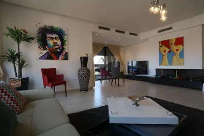 a living room with a couch and a table at Sweet Jacob's Appartment Gueliz City Center in Marrakech