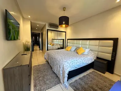a bedroom with a large bed with yellow pillows at Sweet Jacob's Appartment Gueliz City Center in Marrakech