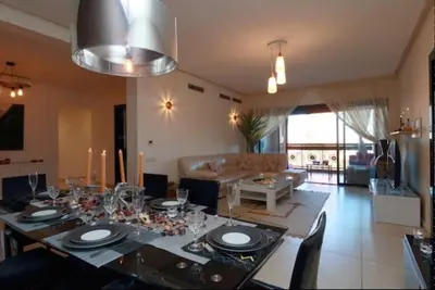 a living room with a dining table with glasses on it at Sweet Jacob's Appartment Gueliz City Center in Marrakech