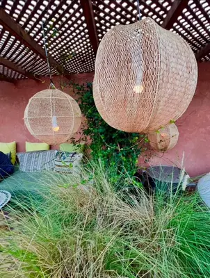 two wicker chandeliers are hanging from a roof at Vibrant Medina Loft and Roof Top in Marrakech