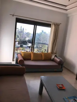 a couch in a living room with a large window at La Fontaine in Marrakech