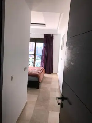a bedroom with a bed and a door with a window at La Fontaine in Marrakech