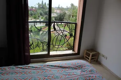a bedroom with a window looking out at a yard at La Fontaine in Marrakech