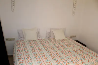 a bed with two pillows on it in a room at La Fontaine in Marrakech