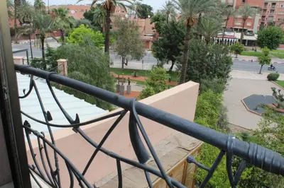 a view of a park from a balcony at La Fontaine in Marrakech