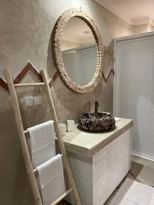 a bathroom with a sink and a mirror at Riad Tsar Mimoun in Marrakech