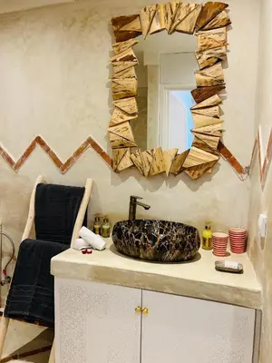 a bathroom with a sink and a mirror on a counter at Riad Tsar Mimoun in Marrakech