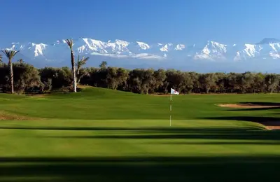 a view of a golf course with mountains in the background at Villa prestige in Marrakech