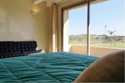 a bedroom with a bed and a large window at Villa prestige in Marrakech