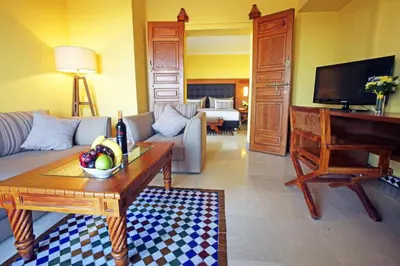 a living room with a couch and a piano at Rose Aqua Park Hotel in Marrakech
