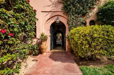 an entrance to a house with an archway and plants at Maison Ayda in Marrakech