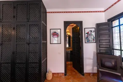 a room with black wooden doors and a hallway at Maison Ayda in Marrakech