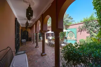an empty hallway with tables and benches in a building at Maison Ayda in Marrakech