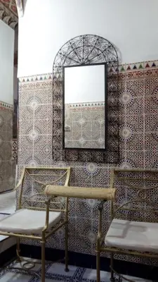 a room with two chairs and a mirror at Hotel Medina in Marrakech