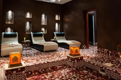 a room with two beds and chairs and a fireplace at Zephyr Targa Marrakech in Marrakech