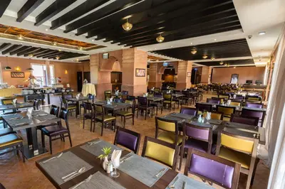 an empty dining room with tables and chairs at Zephyr Targa Marrakech in Marrakech