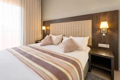 a hotel room with a large bed with two pillows at Zephyr Targa Marrakech in Marrakech