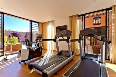 a gym with two treadmills and a treadmill at Al Maaden Villa Hotel & Spa in Marrakech