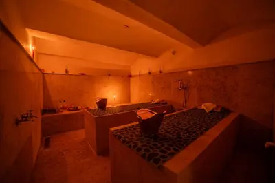a bathroom with a bed and a tub and a sink at Riad Arabic House & Spa in Marrakech