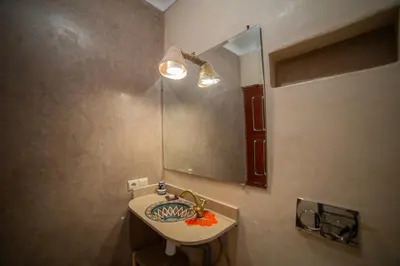 a bathroom with a sink and a mirror at Riad Arabic House & Spa in Marrakech