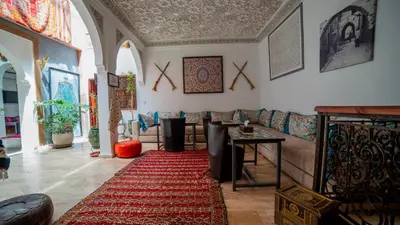 a living room with a couch and a red rug at Riad Arabic House & Spa in Marrakech