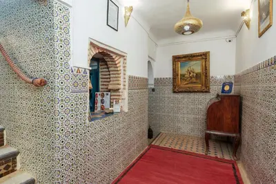 a bathroom with a shower with a red rug at Riad Azalia in Marrakech