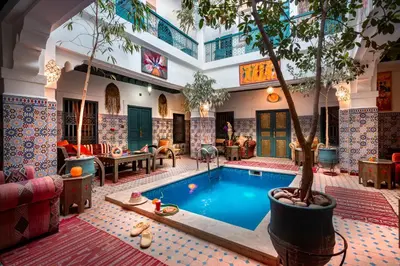 a pool with a tree in the middle of a building at Riad Azalia in Marrakech